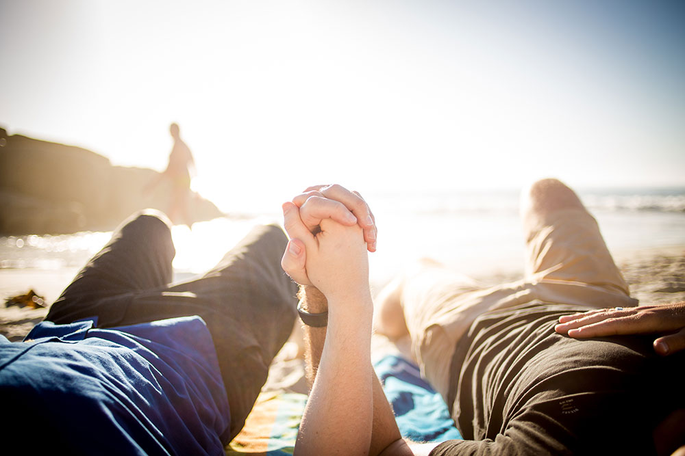 A couple lays on the beach after couples therapy Atlanta