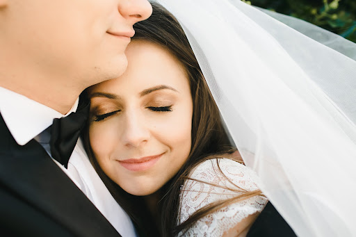 Intimate closeup of a radiant bride with her eyes closed, beaming with joy as she lovingly rests her head on her groom's shoulder - A heartwarming moment captured during a premarital counseling session in Atlanta, Georgia.