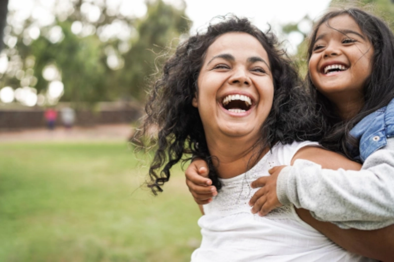 a mother giving her daughter a piggyback ride