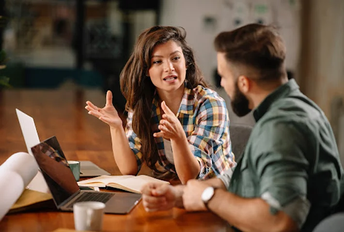Two people discussing work