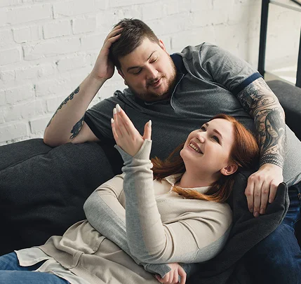 Couple talking on couch