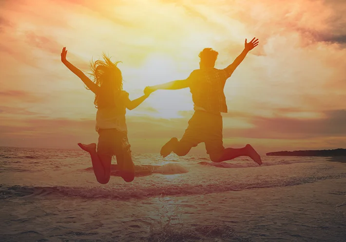 dating-therapy1 Couple jumping at sunset beach