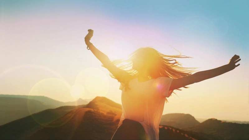Woman celebrating sunset