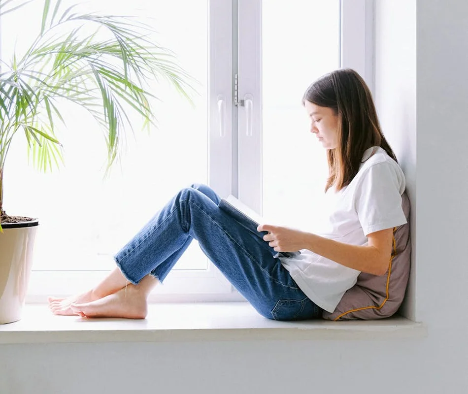 teen therapy Woman reading by window